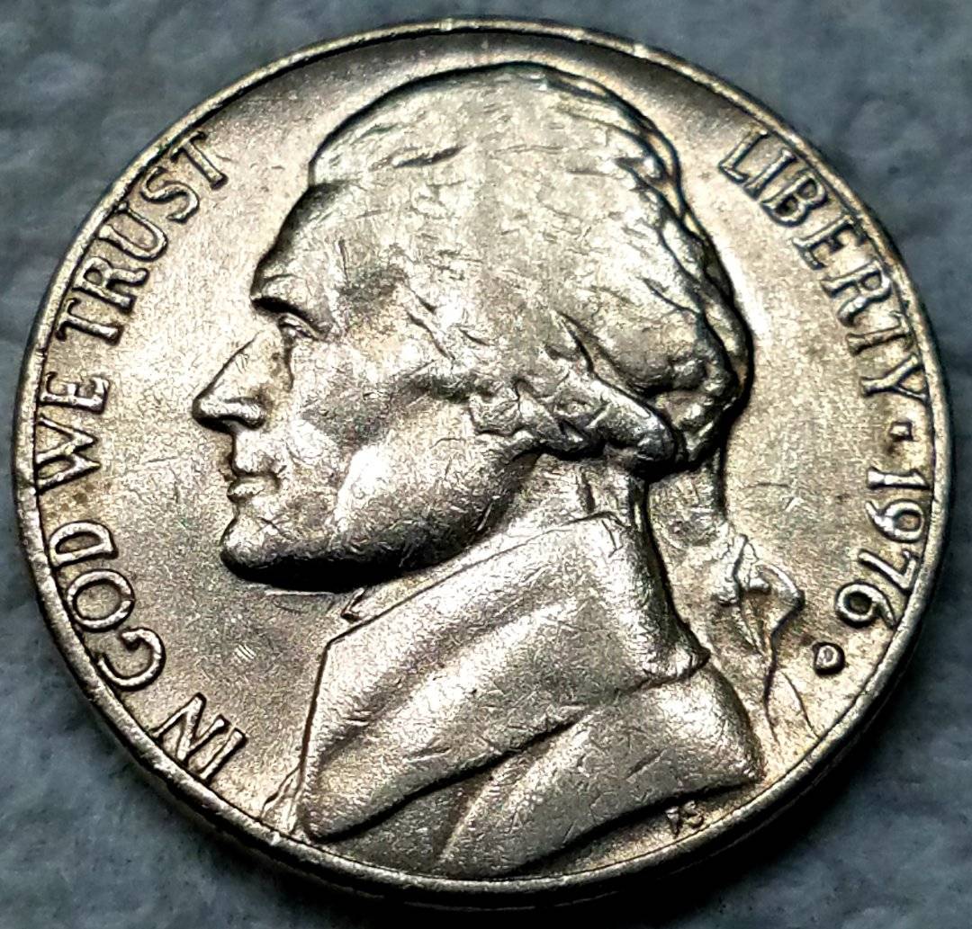 1976-D-Jefferson-Nickel-Tilted-Die-Strike-Under-Jaw-On-Obverse?